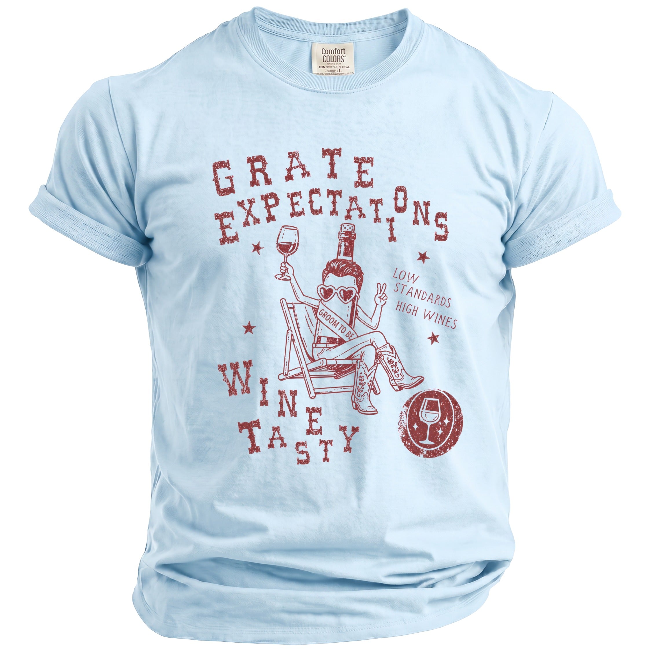 Light blue t-shirt with red text and graphic of a wine bottle wearing heart sunglasses and cowboy boots.