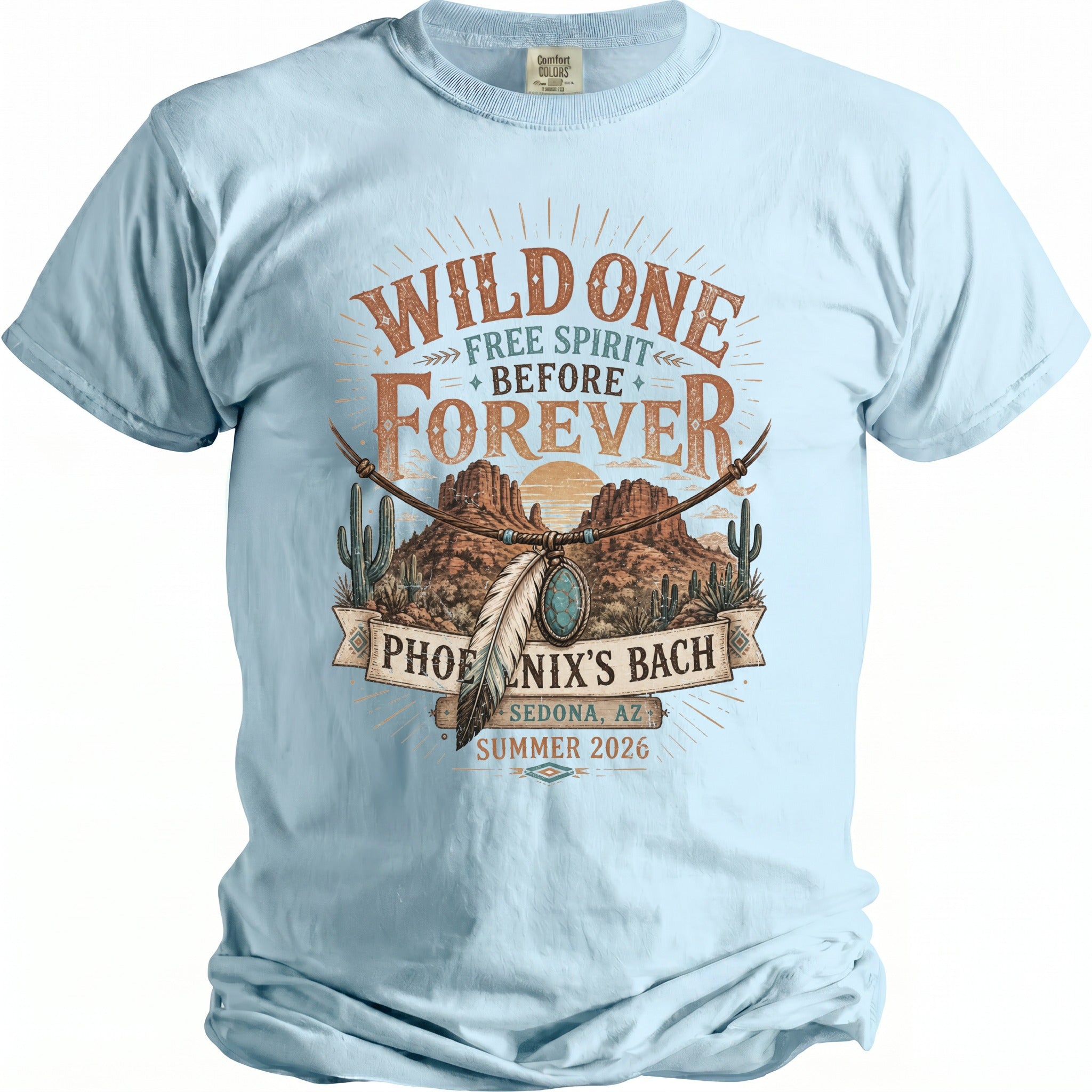 Light blue t-shirt with "Wild One Free Spirit Before Forever Phoenix's Bach Sedona, AZ Summer 2026" graphic.