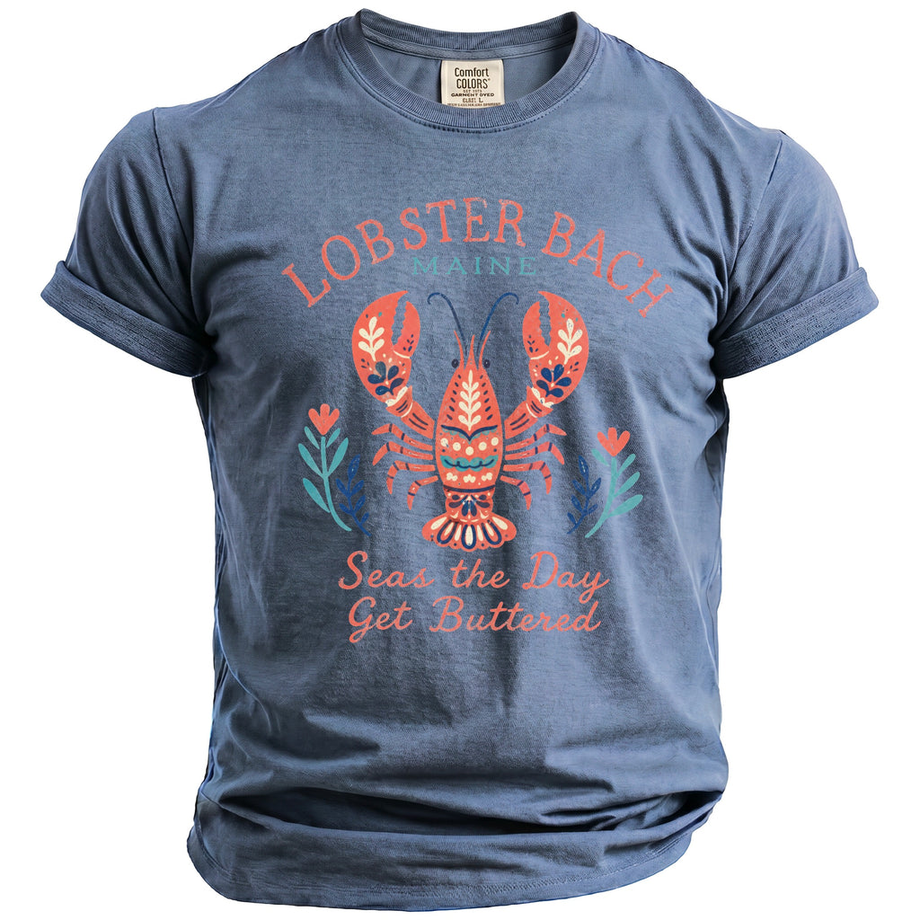 Blue t-shirt with lobster graphic and text "Lobster Back Maine Seas the Day Get Buttered".