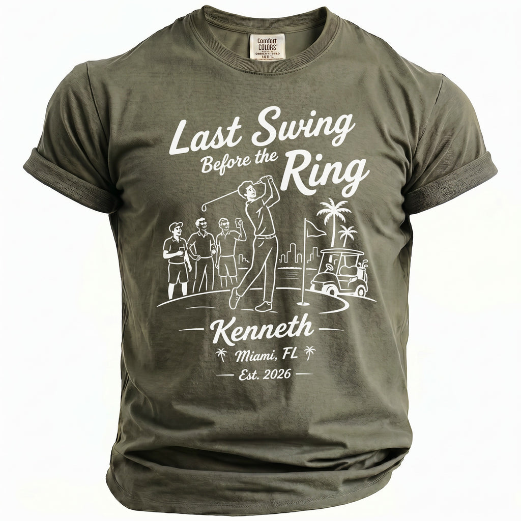 Olive green t-shirt with white graphic: golf scene, "Last Swing Before the Ring Kenneth Miami, FL Est. 2026".