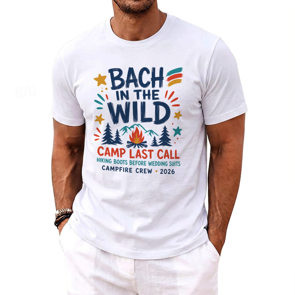 White t-shirt with "Bach in the Wild" text, campfire, and mountains graphic.