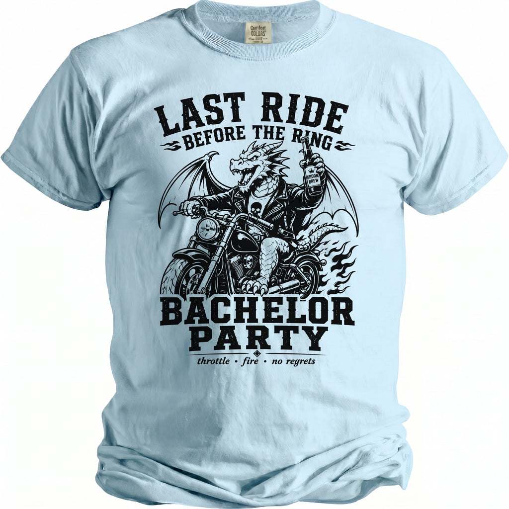 Light blue t-shirt with a black graphic of a dragon on a motorcycle holding a beer, titled "Last Ride Before The Ring" and "Bachelor Party".