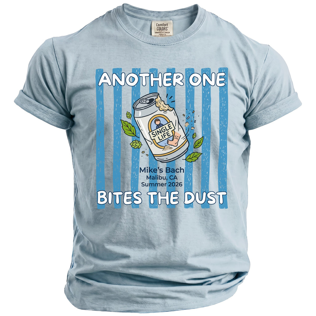Light blue t-shirt with "Another One Bites The Dust" text and a beer can graphic.