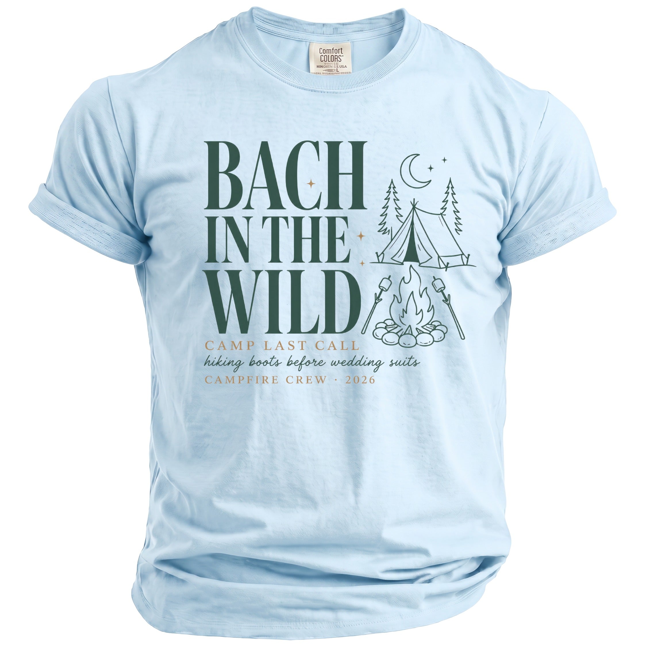 Light blue t-shirt with "Bach In The Wild" text, camping graphics, and "Campfire Crew 2026" text.