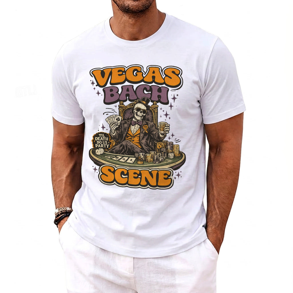 White t-shirt with "Vegas Bach Scene" text and skeleton gambling illustration.