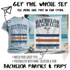 Light blue t-shirt and beach towel with "Bachelor Beach Club" and "Groom's Beach Weekend - 2026".