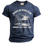 Navy t-shirt with "Bachelor Beach Club Groom's Last Wave 2026" graphic.