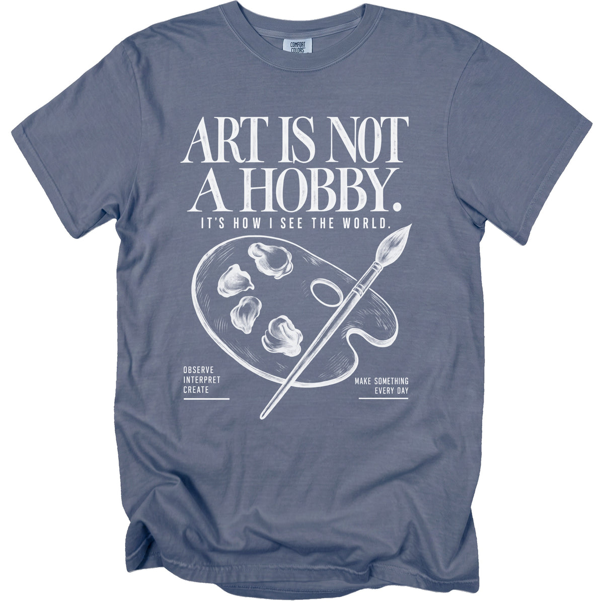 T-shirt with white text "ART IS NOT A HOBBY. IT'S HOW I SEE THE WORLD." and art palette.