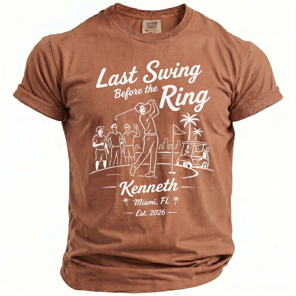 Brown t-shirt with "Last Swing Before the Ring" graphic including golfers and text.