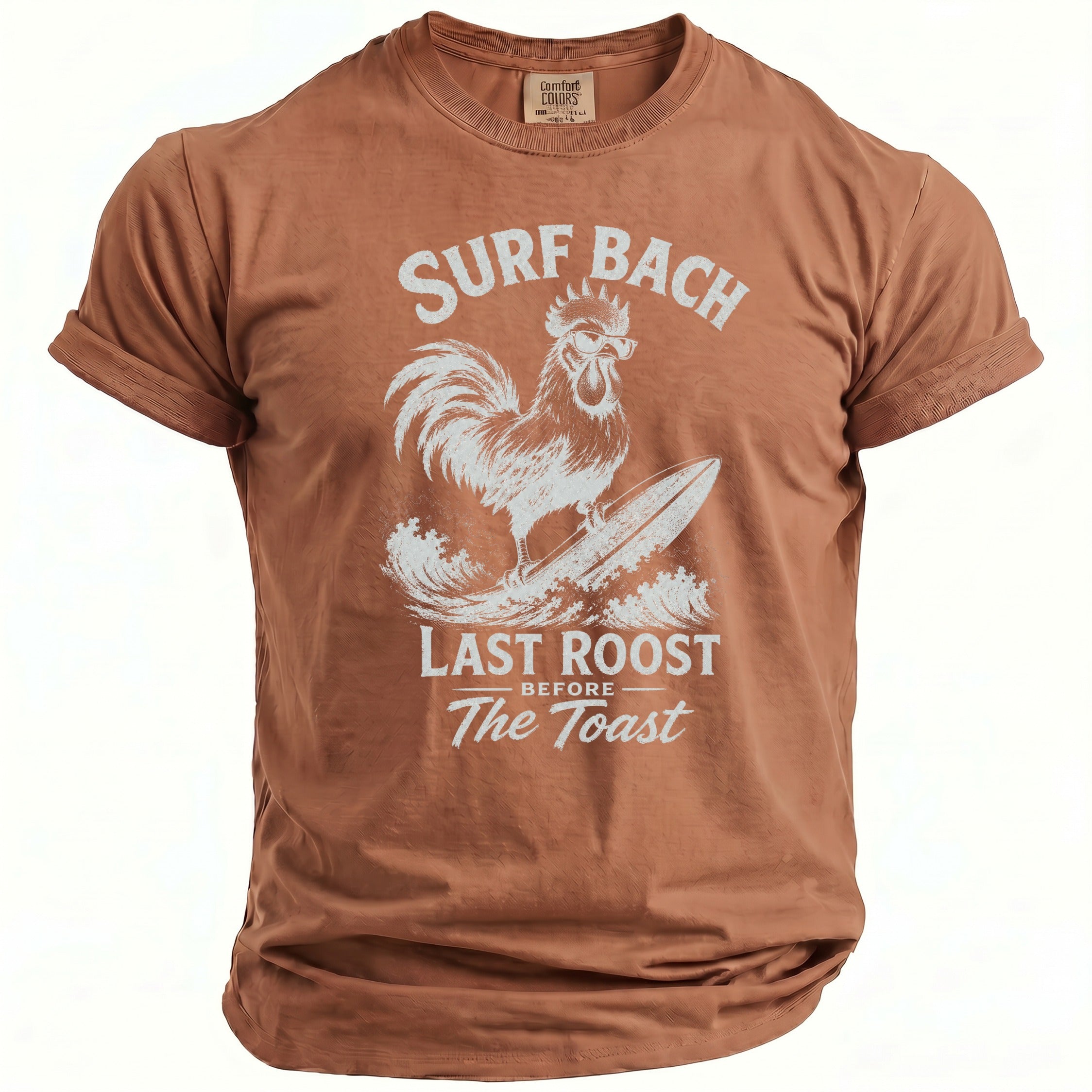 Brown t-shirt with a rooster surfing graphic and text "SURF BACH LAST ROOST BEFORE The Toast".