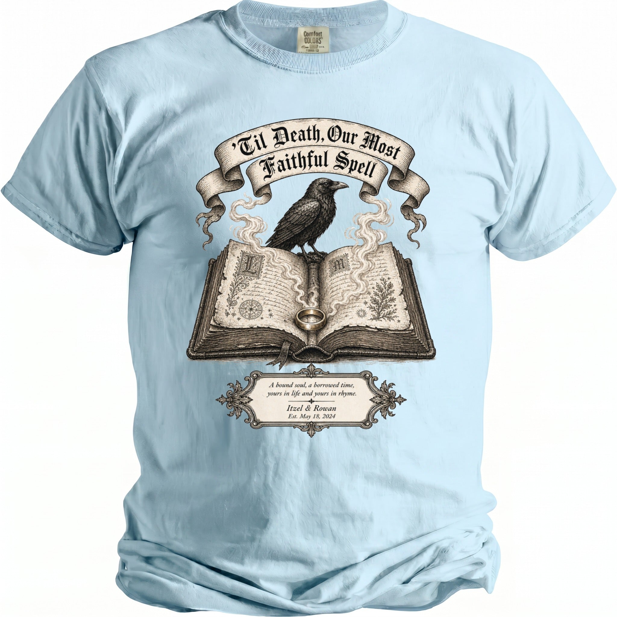 Light blue t-shirt with raven on book, reads "Til Death, Our Most Faithful Spell."