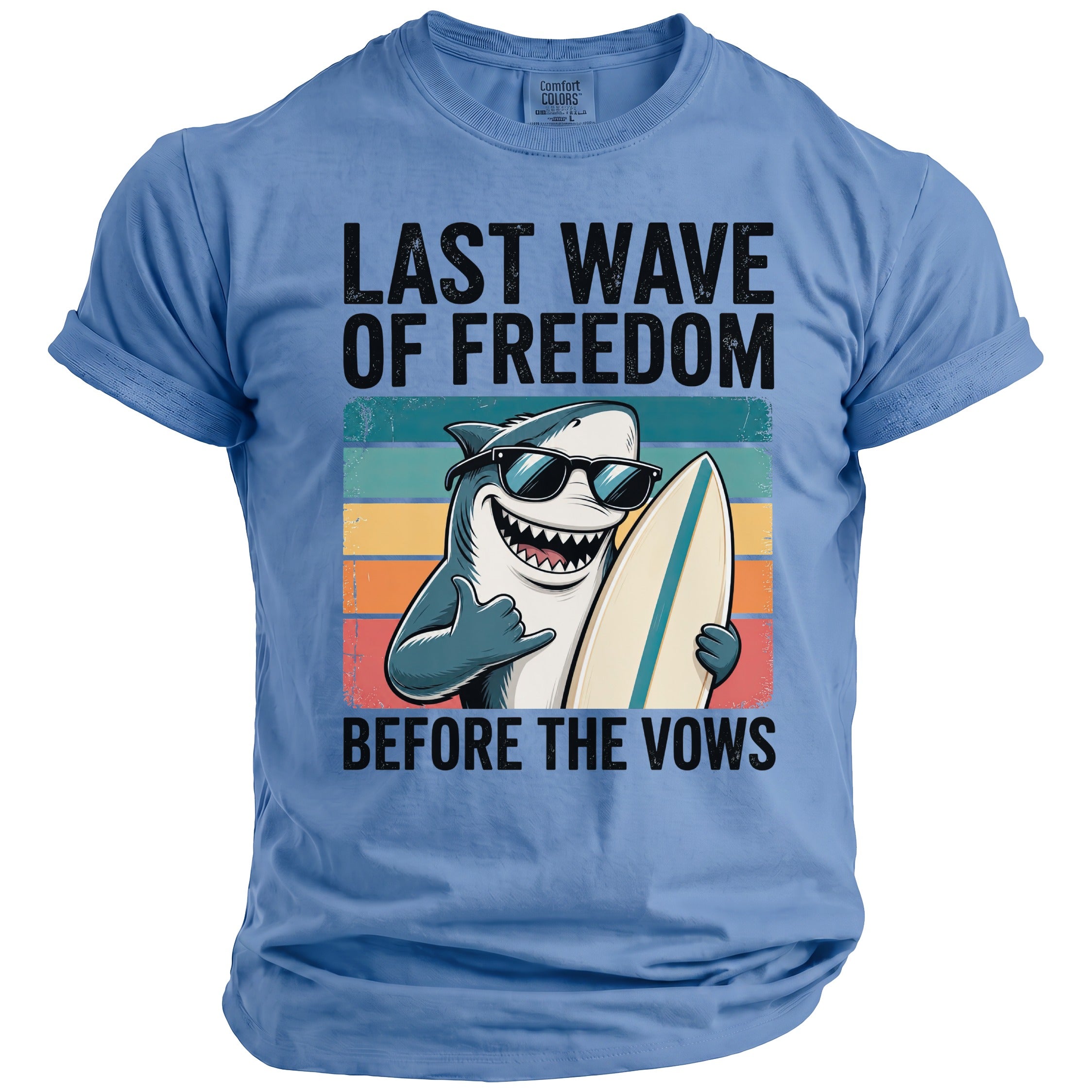 Blue t-shirt with shark holding surfboard and text "LAST WAVE OF FREEDOM BEFORE THE VOWS".