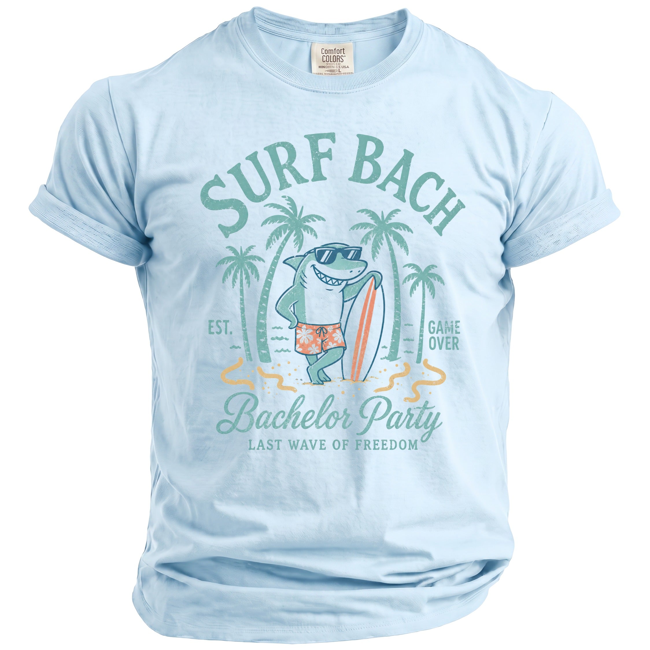 Light blue t-shirt with a graphic of a shark holding a surfboard, "Surf Bach" and "Bachelor Party".