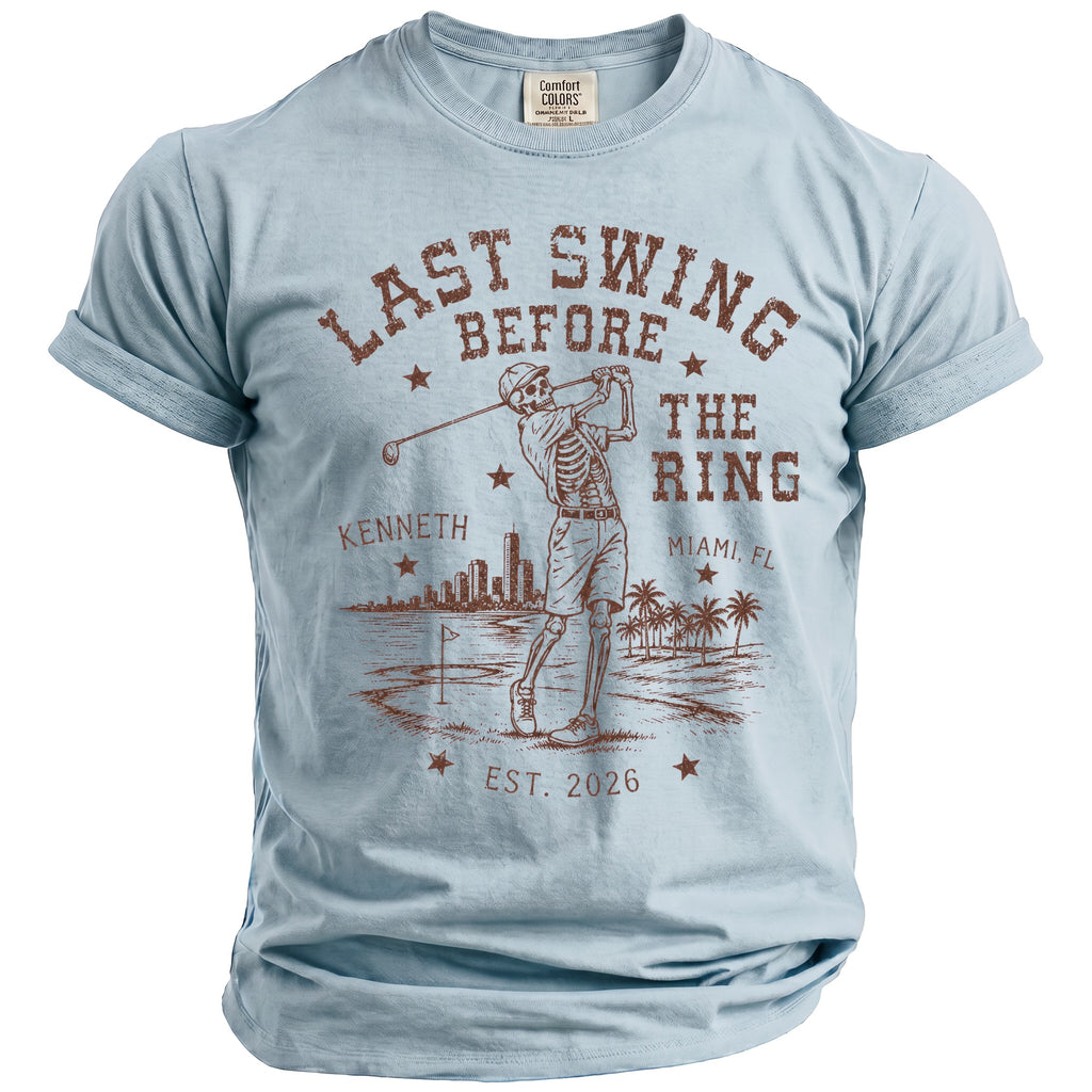 Light blue t-shirt with skeleton golfer graphic and text "Last Swing Before The Ring Miami, FL"