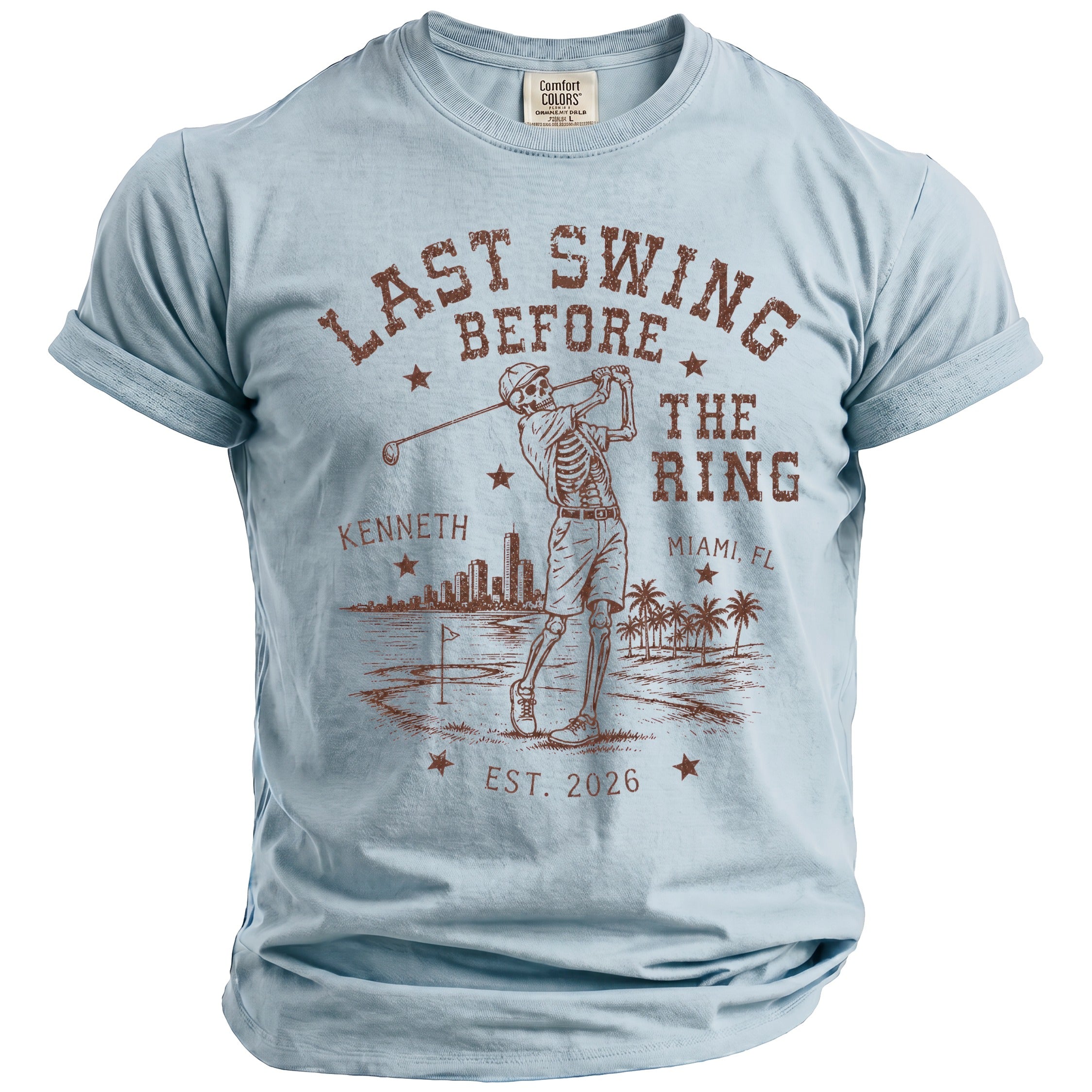 Light blue t-shirt with skeleton golfer graphic and text "Last Swing Before The Ring Miami, FL"