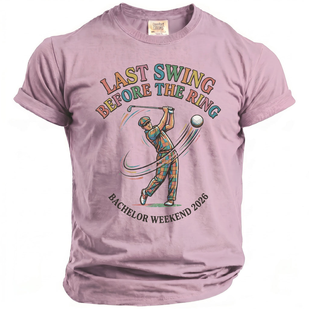 Lavender t-shirt with graphic of golfer and text "LAST SWING BEFORE THE RING BACHELOR WEEKEND 2026".