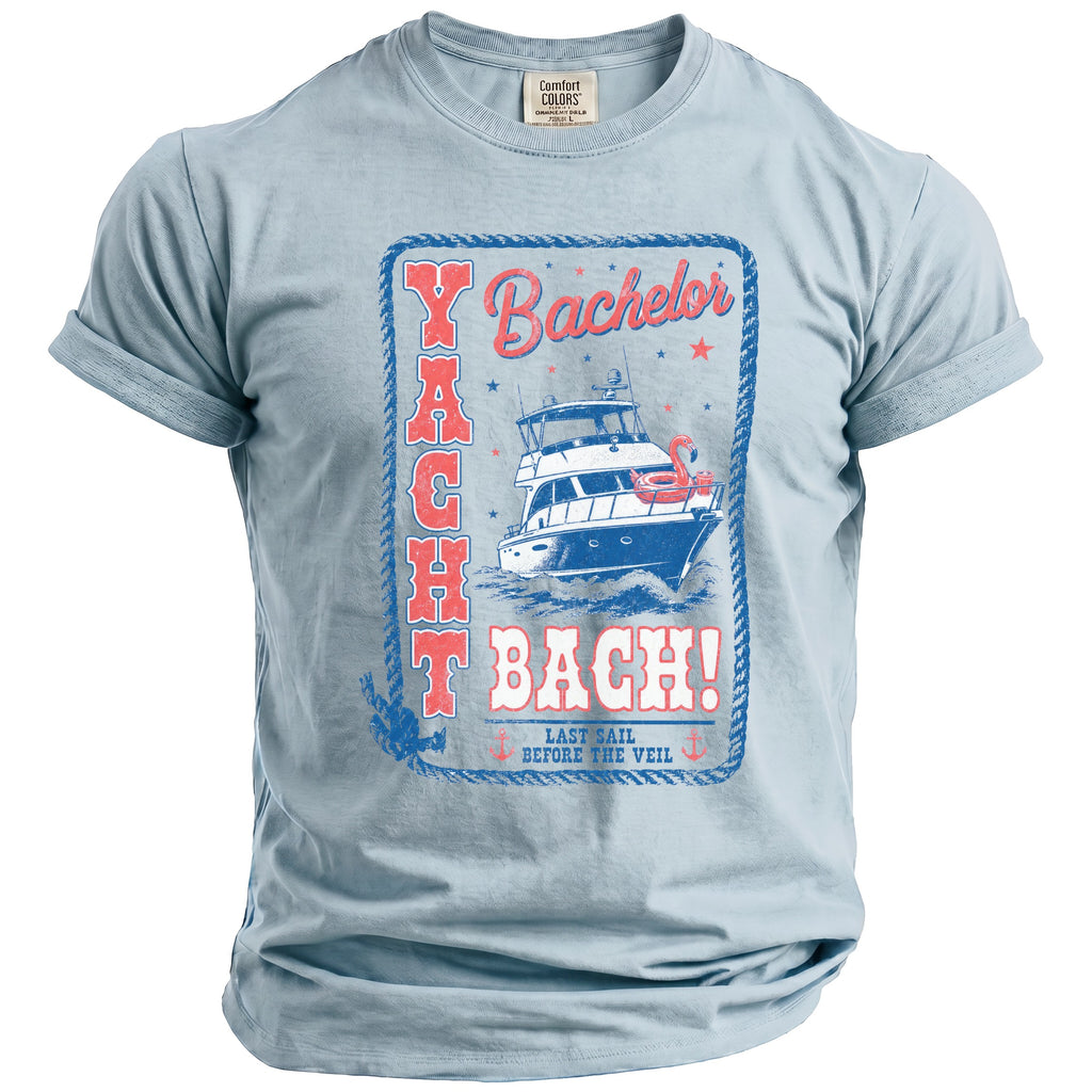 A light blue crewneck t-shirt with a vintage graphic featuring a yacht and text reading Yacht Bach.