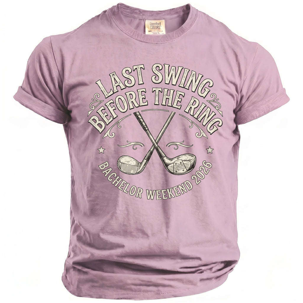 Purple t-shirt with crossed golf clubs and text: "LAST SWING BEFORE THE RING BACHELOR WEEKEND 2026".
