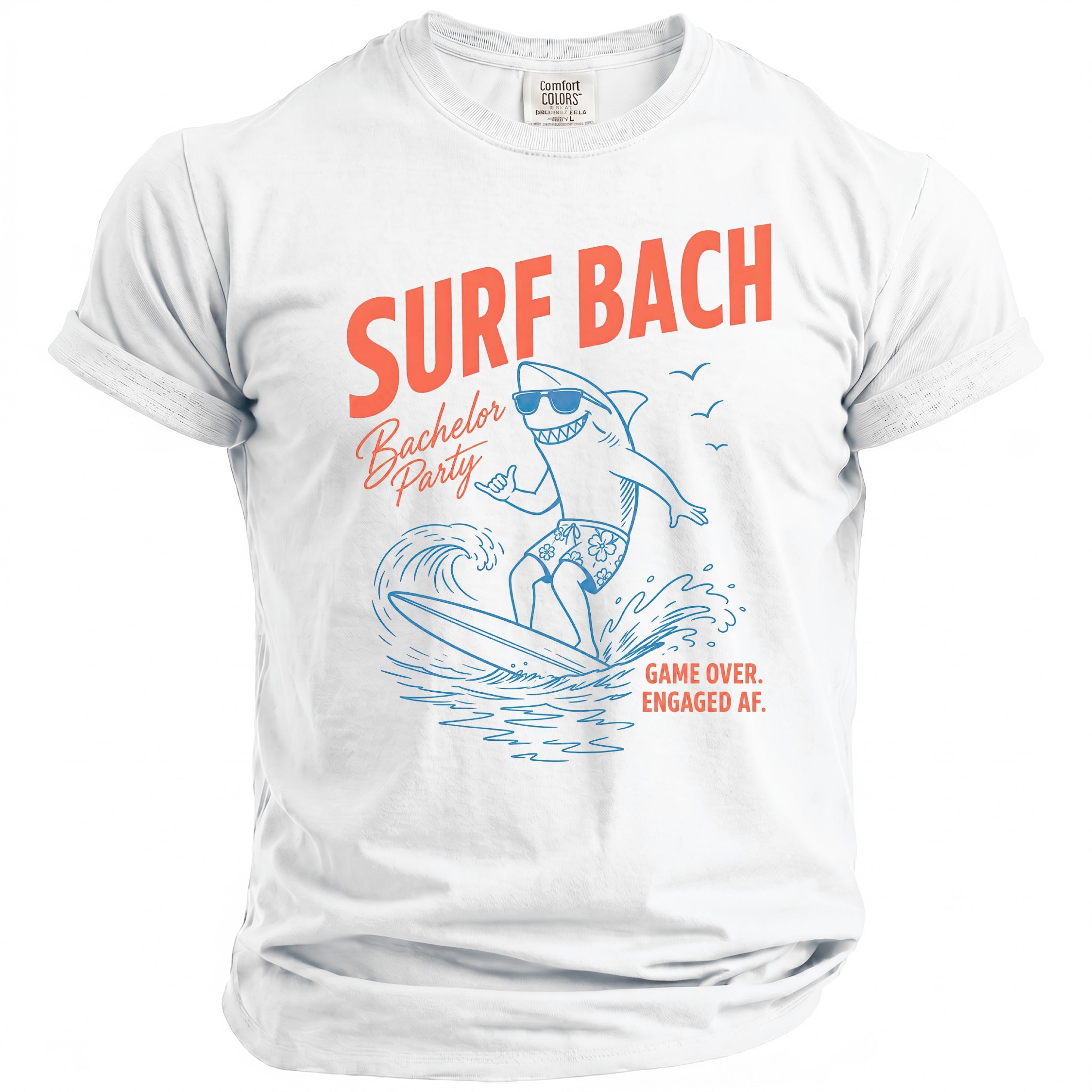 White t-shirt with a shark surfing graphic and text "SURF BACH Bachelor Party GAME OVER. ENGAGED AF."