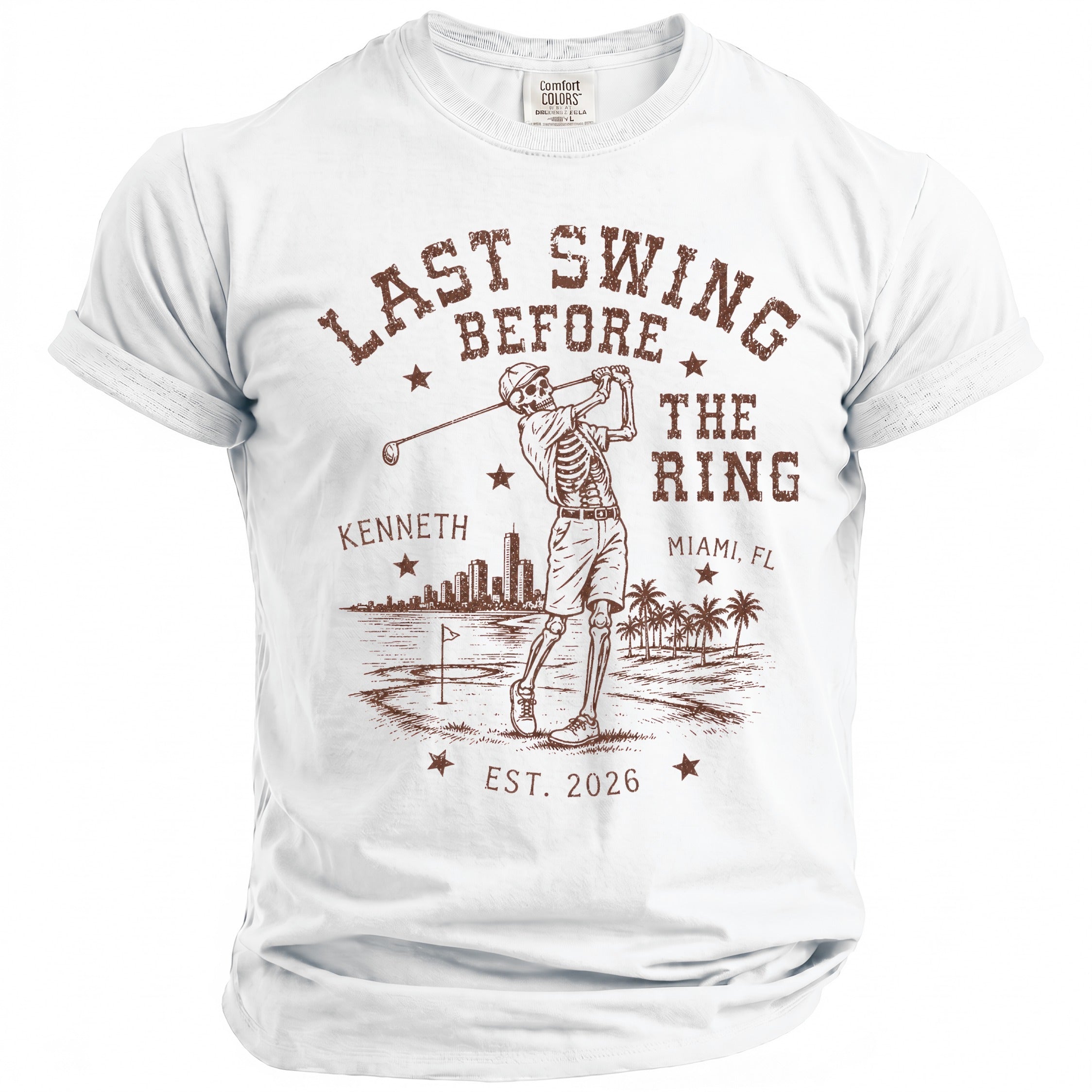 Graphic t-shirt with skeleton golfer, text "Last Swing Before The Ring", "Kenneth", "Miami, FL", and "Est. 2026".