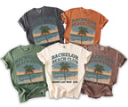 T-shirts feature "Bachelor Beach Club" graphic with palm tree and ocean sunset.