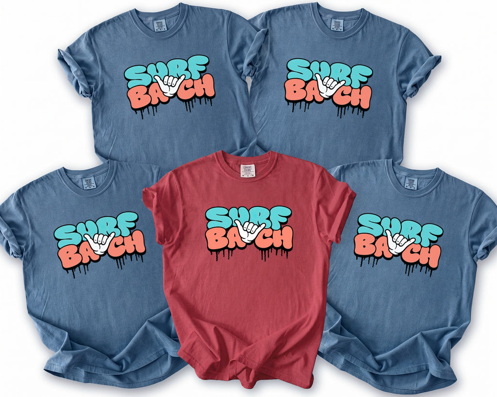 Four blue and one red t-shirt with "SURF BACH" graphic and shaka hand symbol.