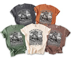 Five t-shirts in different colors featuring a dragon playing poker with text about Las Vegas.