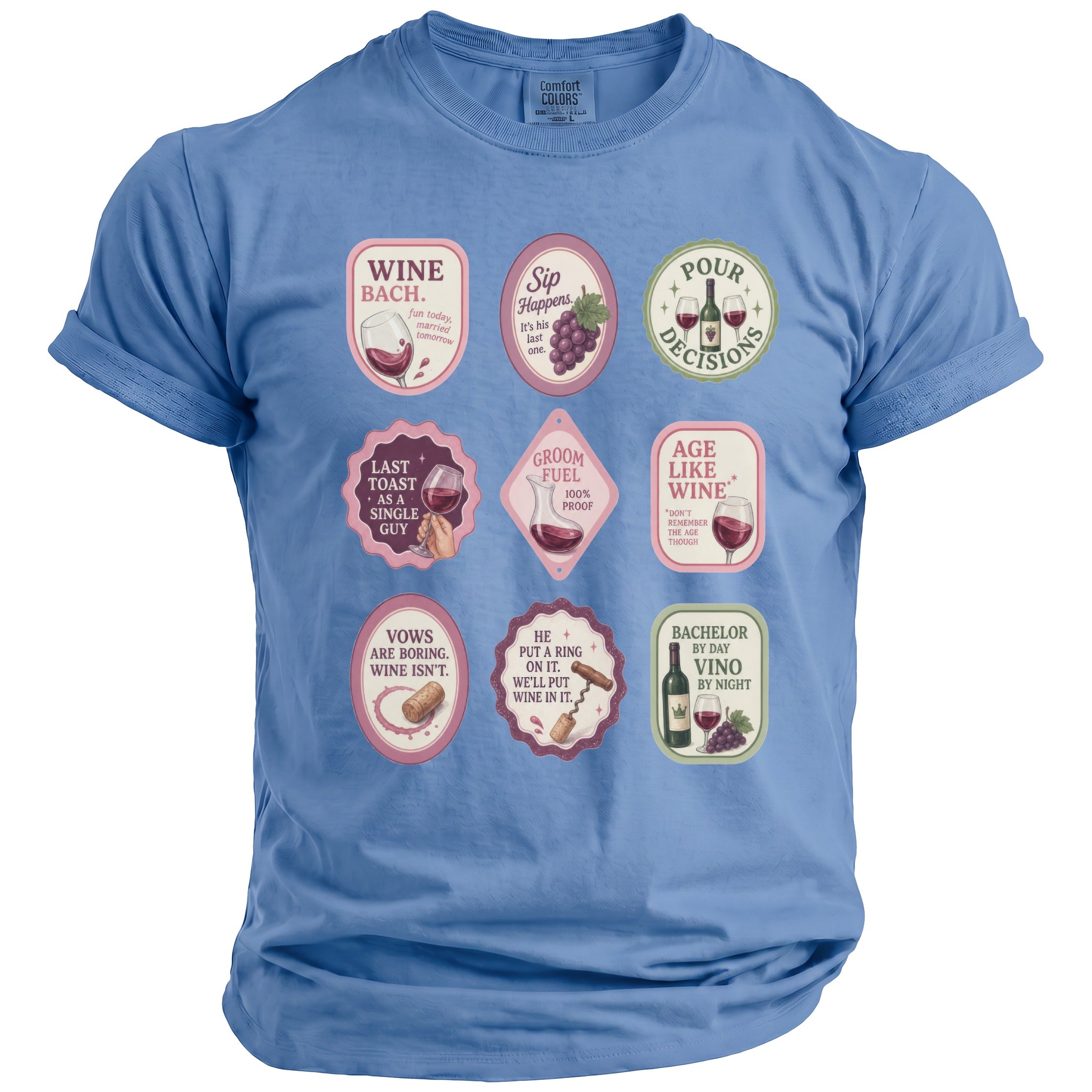 Blue t-shirt with nine wine-themed badges: Wine Bach, Sip Happens, Pour Decisions, Last Toast, Groom Fuel, Age Like Wine, Vows, He Put a Ring, and Bachelor.