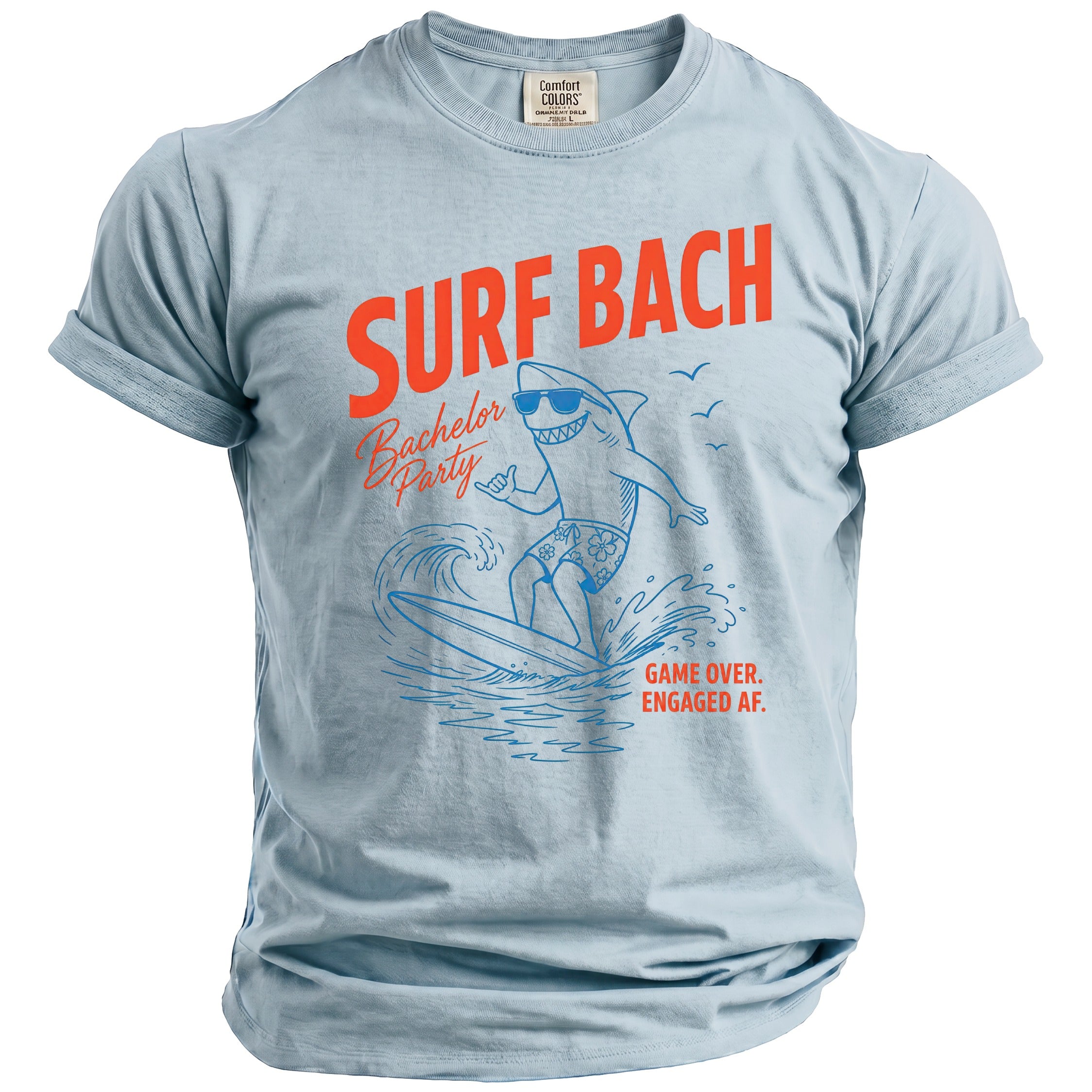 Light blue t-shirt with orange text "SURF BACH Bachelor Party" and shark graphic.