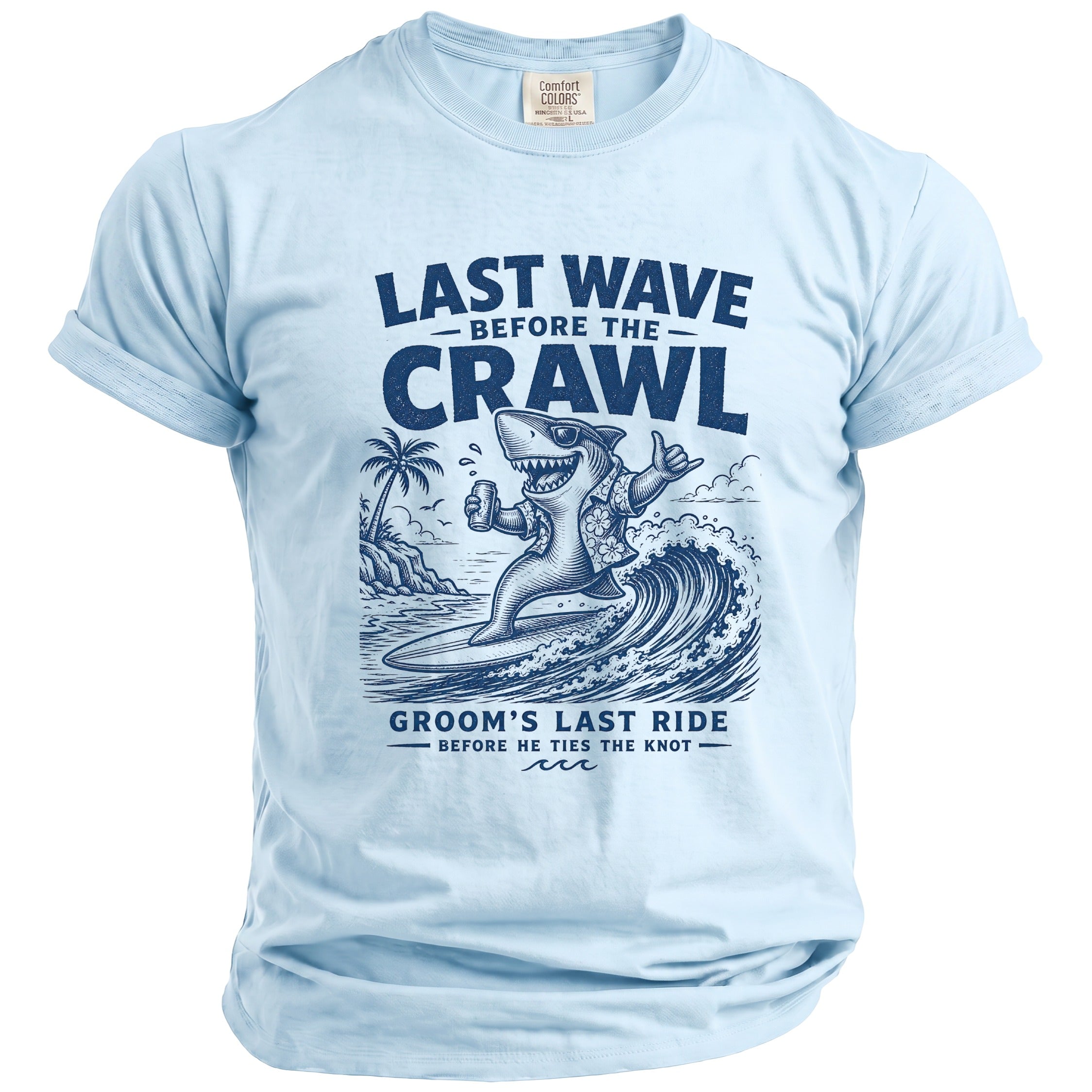 Blue t-shirt with a graphic of a shark surfing a wave, holding a beer, with text "Last Wave Before the Crawl Groom's Last Ride".