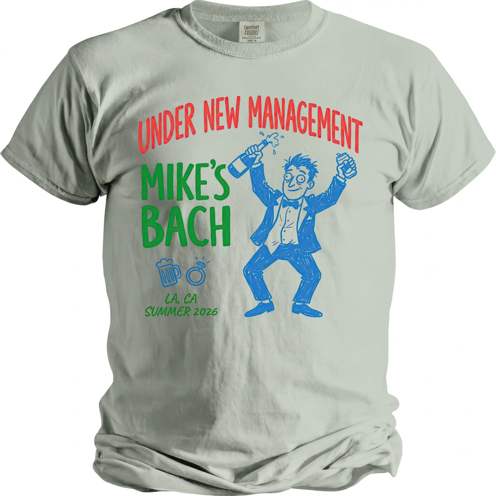 Light grey t-shirt with "Under New Management Mike's Bach" text and cartoon groom.