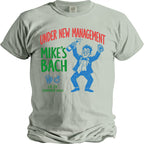 Light grey t-shirt with "Under New Management Mike's Bach" text and cartoon groom.