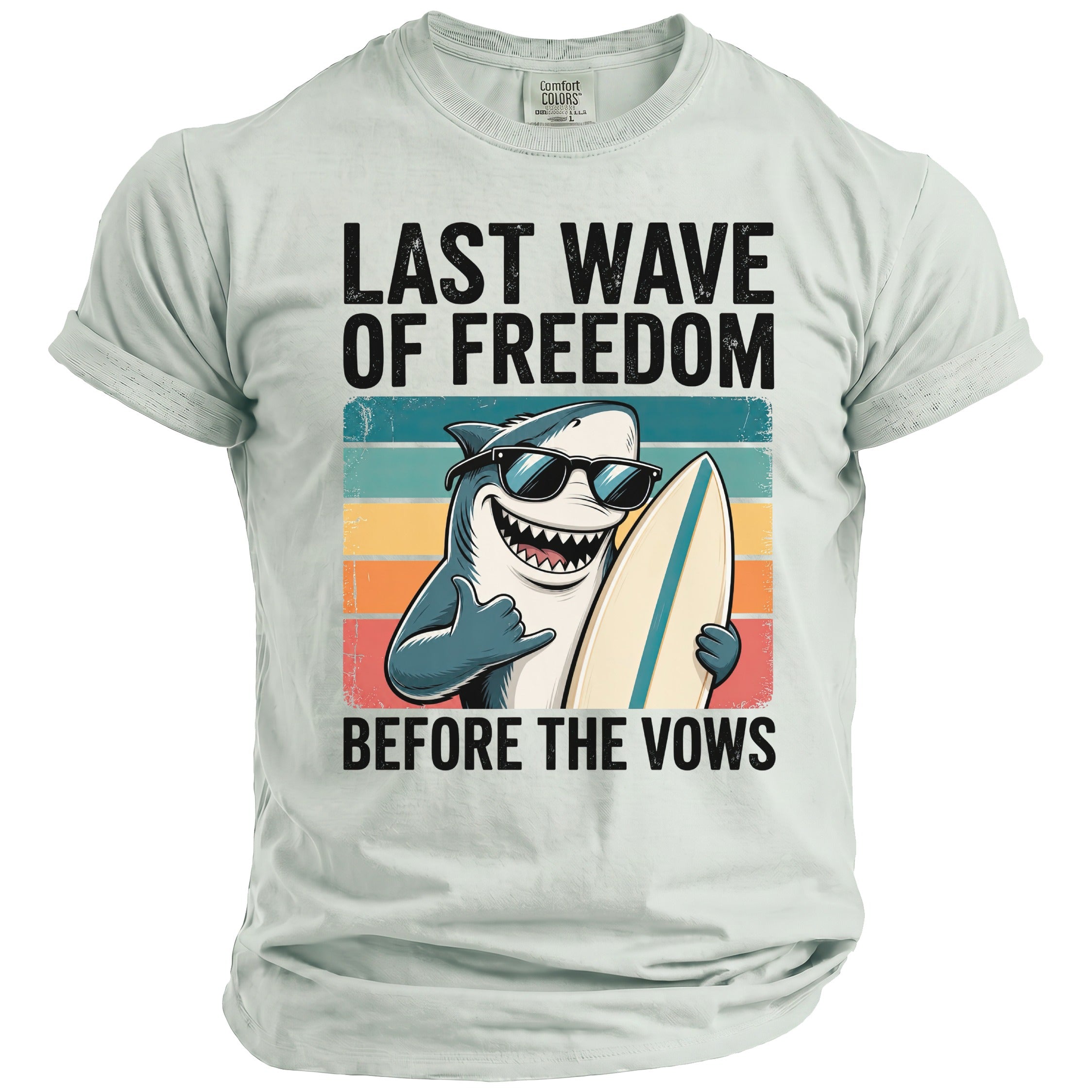 Shirt with shark wearing sunglasses holding surfboard, text "LAST WAVE OF FREEDOM BEFORE THE VOWS".
