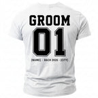 White t-shirt with "GROOM 01" and "[NAME] BACH 2026 [CITY]" printed on the back.