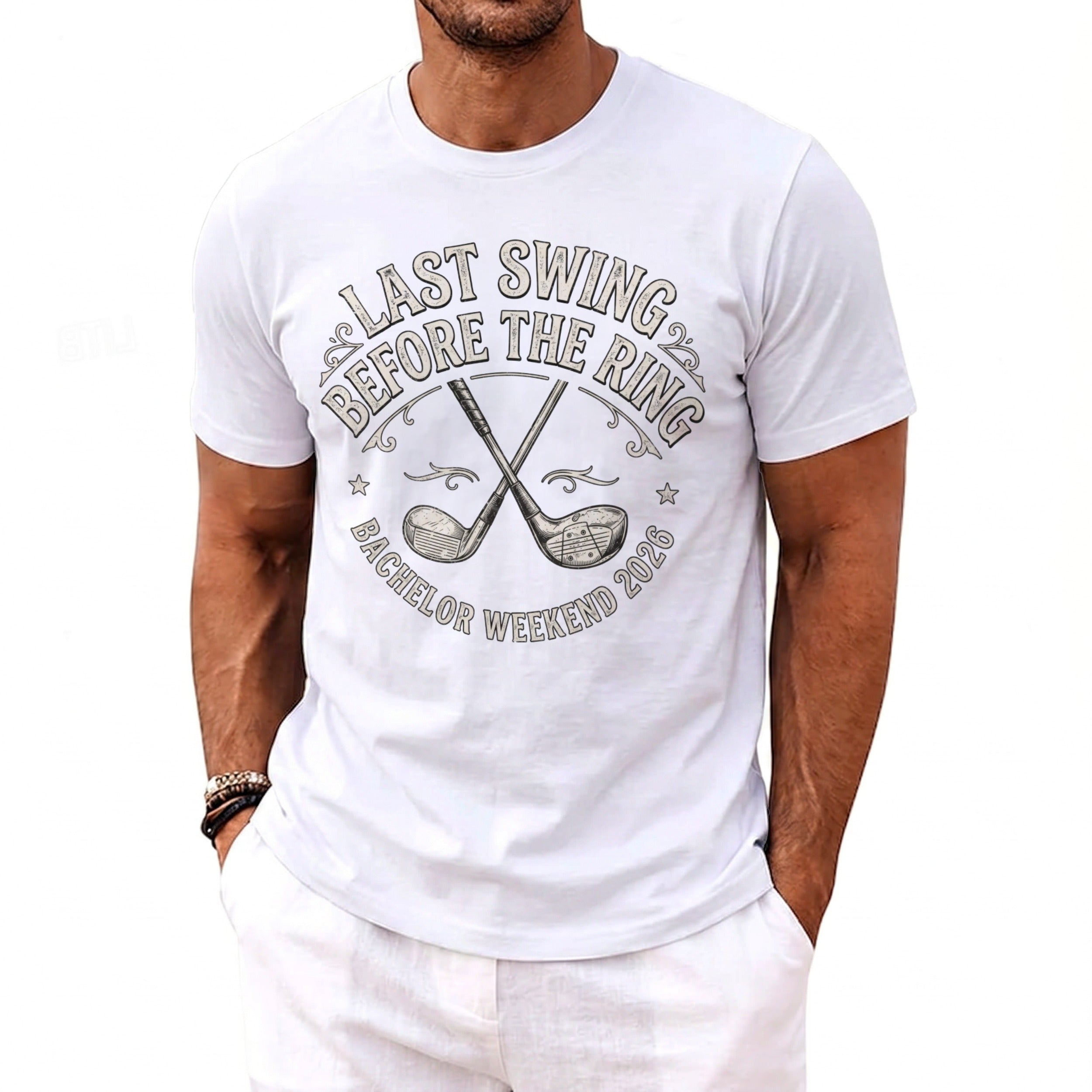 White t-shirt with text "Last Swing Before The Ring Bachelor Weekend 2026" and crossed golf clubs.