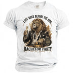 White t-shirt with a lion holding a champagne glass, "Last Roar Before the Ring" and "Bachelor Party" text.