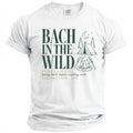 White t-shirt with "Bach in the Wild" text, campfire, tent, and moon graphic.