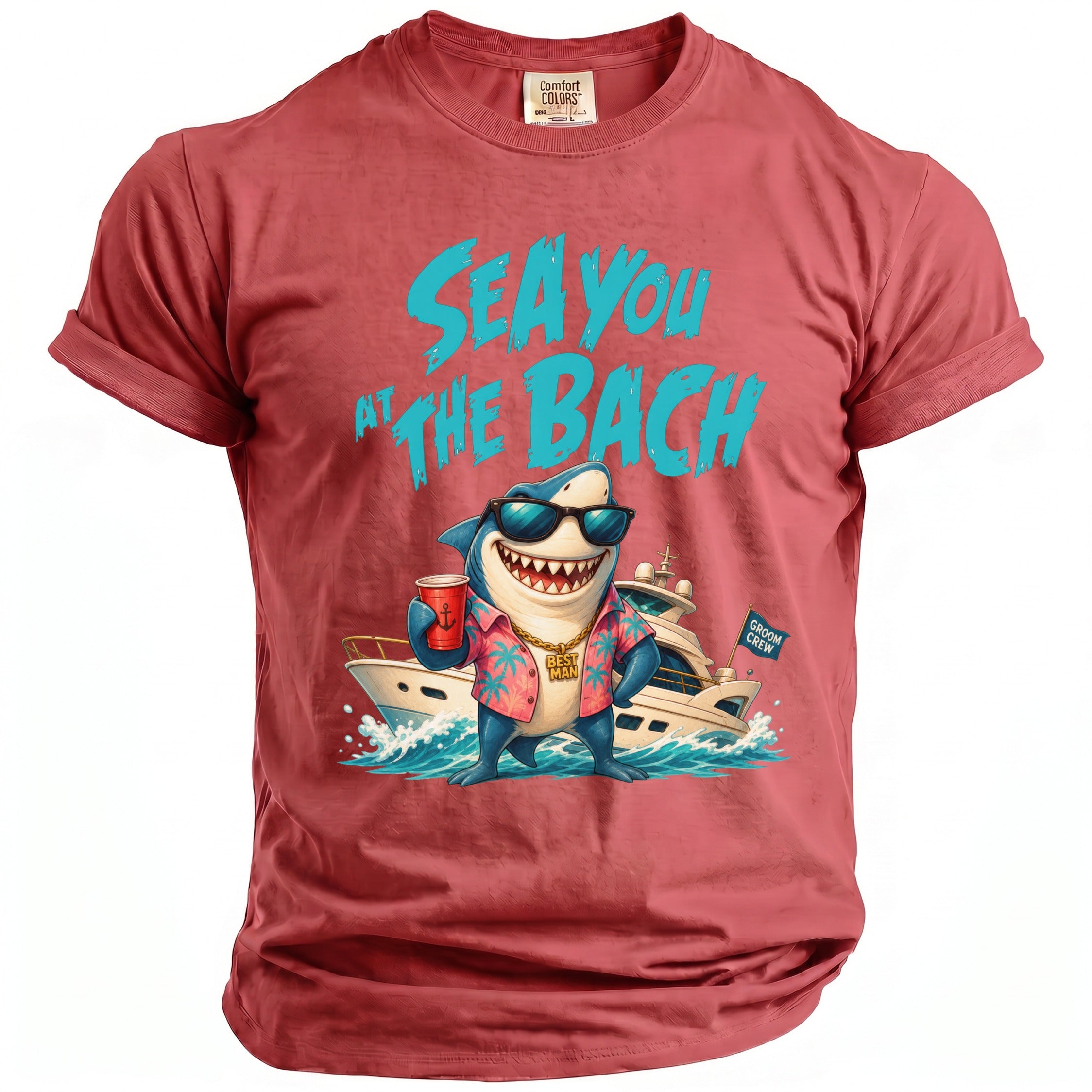 A red t-shirt featuring a graphic of a shark wearing sunglasses, a floral shirt, and a gold chain, standing in front of a yacht with the text Sea You at the Bach.