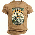 Tan t-shirt with "ALPINE BACH" and mountain beer mug graphic.