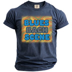 Dark blue t-shirt with "BLUES BACH SCENE" text and colorful wavy pattern.