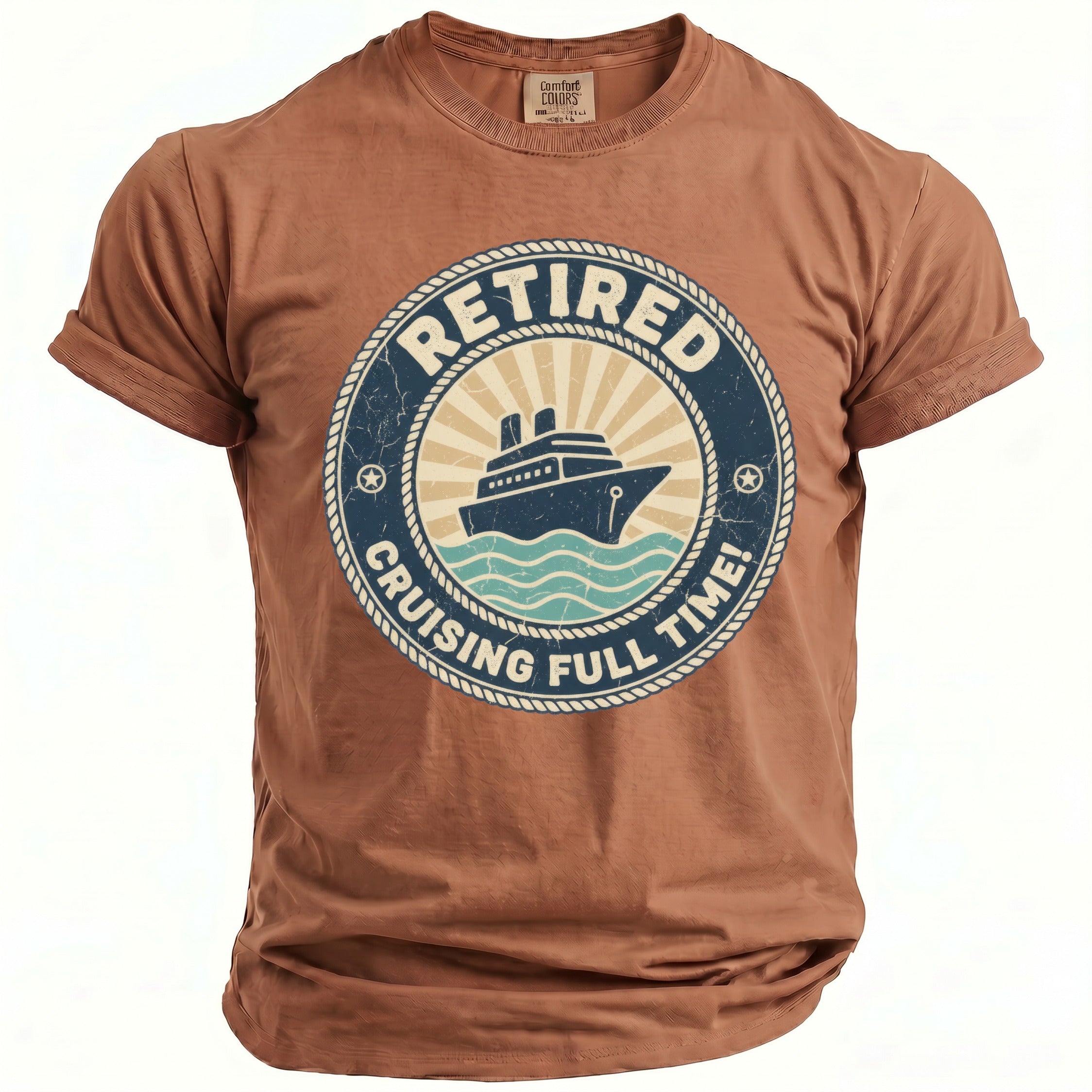 A brown t-shirt featuring a circular graphic with a cruise ship and text that reads Retired Cruising Full Time.