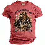 Rose-colored shirt with a lion in a suit holding champagne and text about a bachelor party.