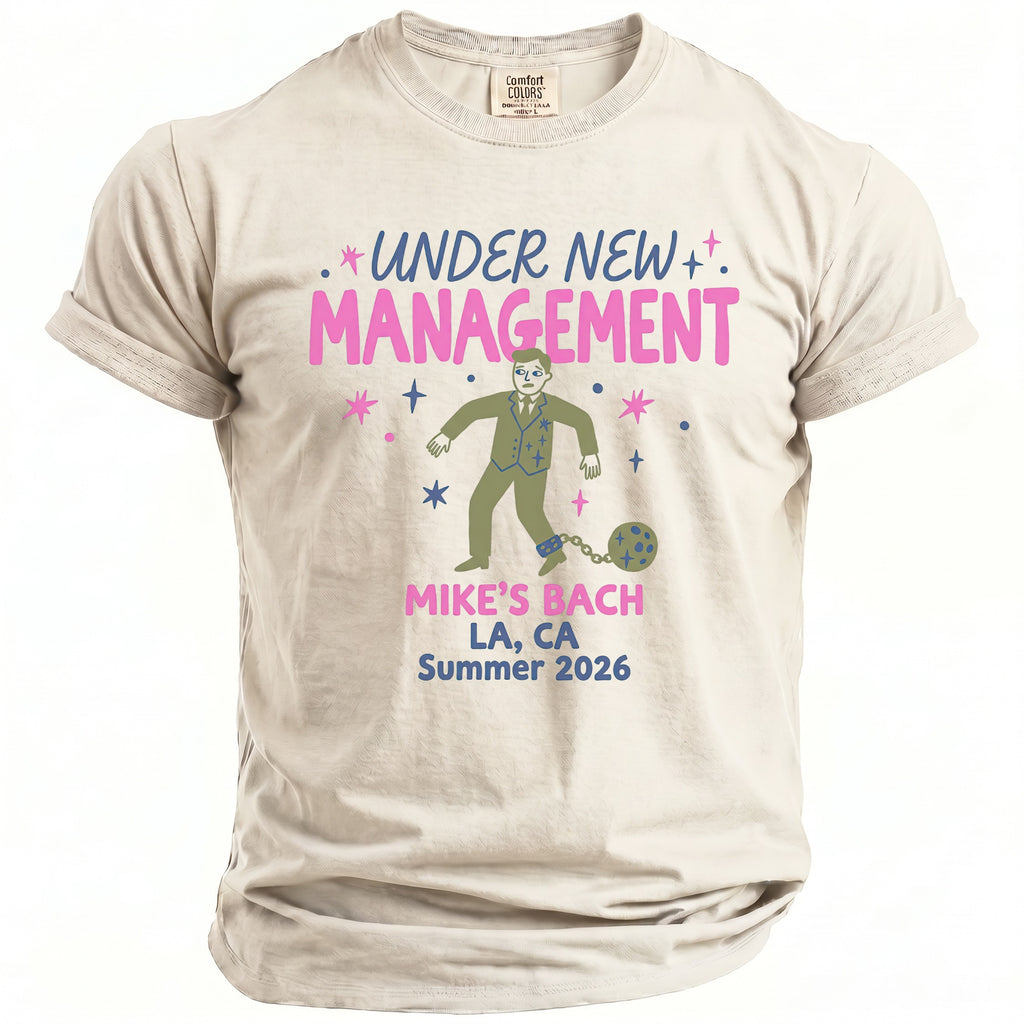 T-shirt with "Under New Management" and a man shackled on "Mike's Bach LA, CA Summer 2026".