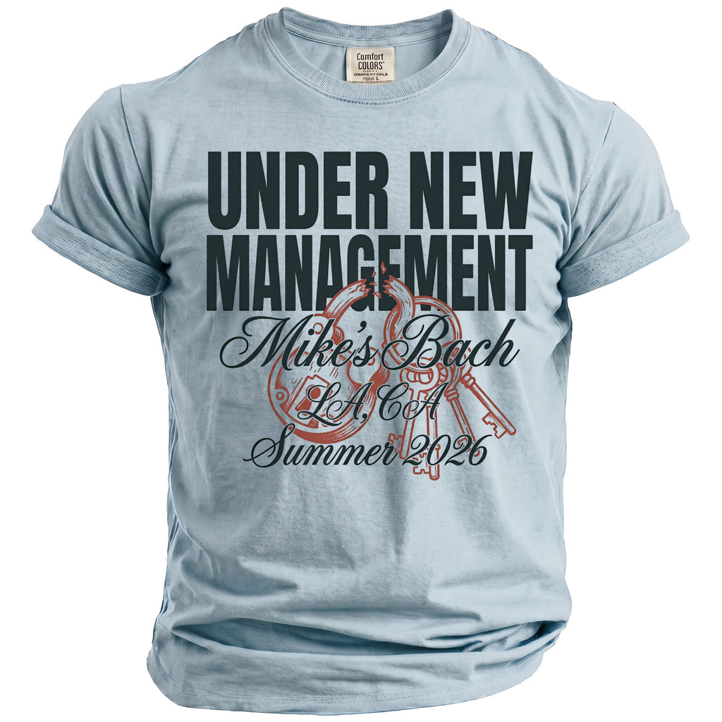 Light blue t-shirt with "UNDER NEW MANAGEMENT", "Mike's Bach", "LA, CA", and "Summer 2026" graphics.