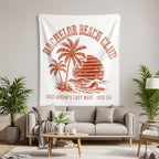 White tapestry with orange text "BACHELOR BEACH CLUB GROOM'S LAST WAVE 2026".