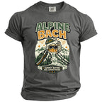T-shirt graphic with "ALPINE BACH" text, beer mug waterfall, and mountains.
