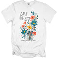 White t-shirt with "ART IN BLOOM" and floral art with paintbrushes.