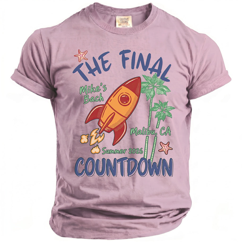 Lavender "The Final Countdown" t-shirt with rocket, palm trees, and starfish graphics.