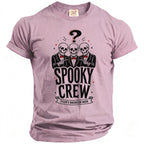 Pink t-shirt with a graphic of three skeletons in suits pointing, a question mark, and the text "SPOOKY CREW TYLER'S BACHELOR BASH".