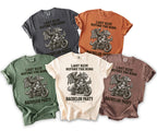T-shirts feature a dragon riding a motorcycle with text "LAST RIDE BEFORE THE RING".